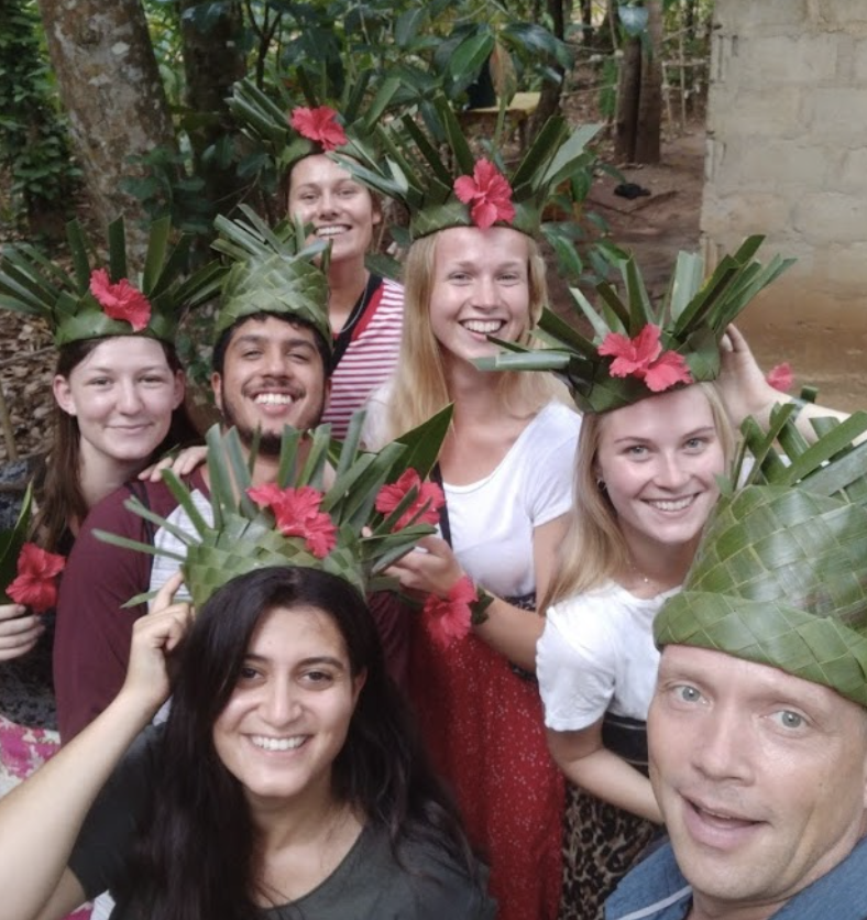 Sheila, a Danish volunteer, poses with other volunteers in bamboo hats